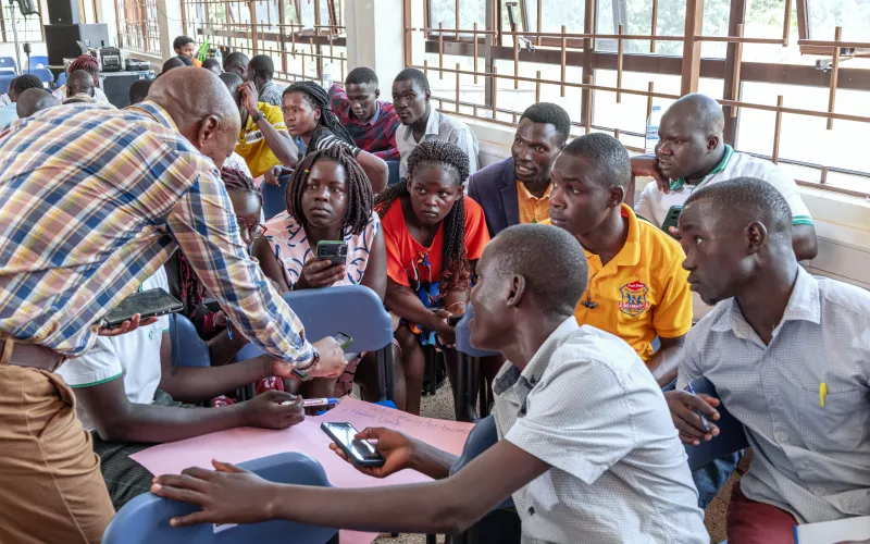 Facilitator interacts with university students during a group discussion activity