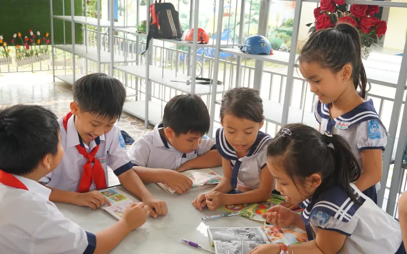 Children play around a table in Vietnam