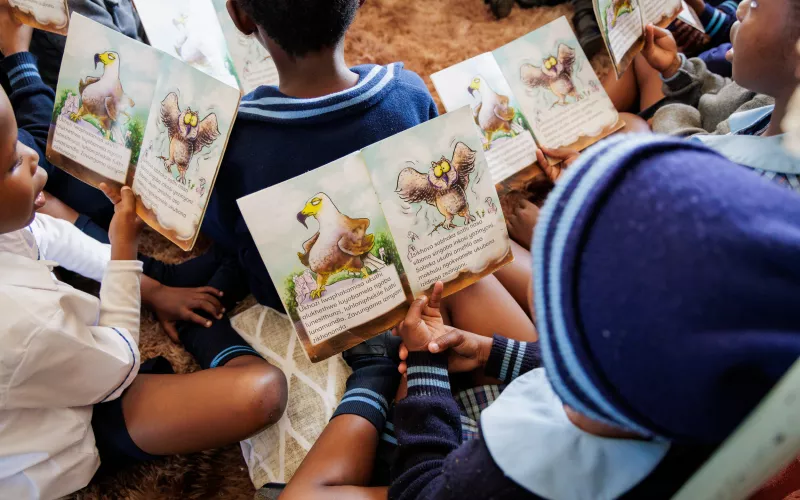 Preschool children in South Africa reading.