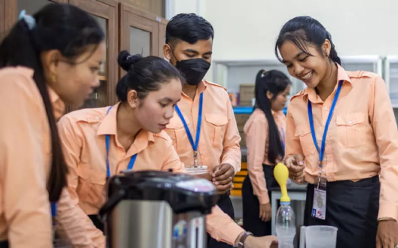 Students waering orange uniforms in a science lab