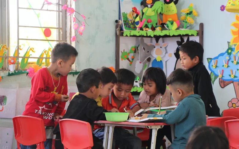Children doing group work in the classroom.