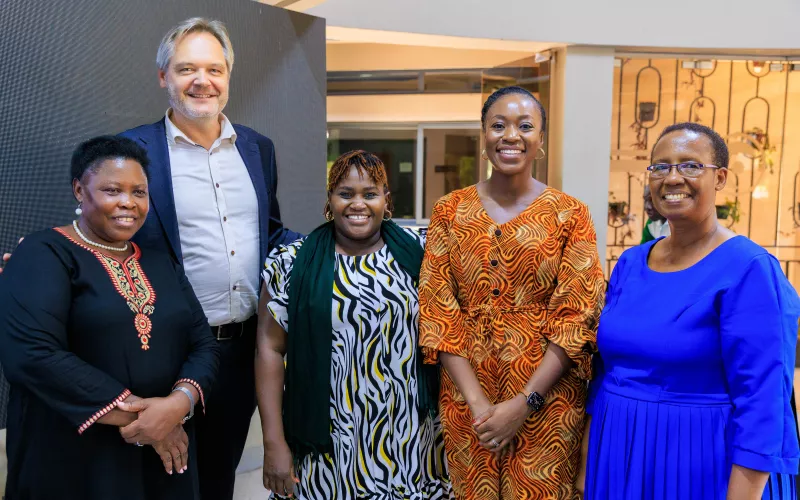 Group photo of five people smiling.