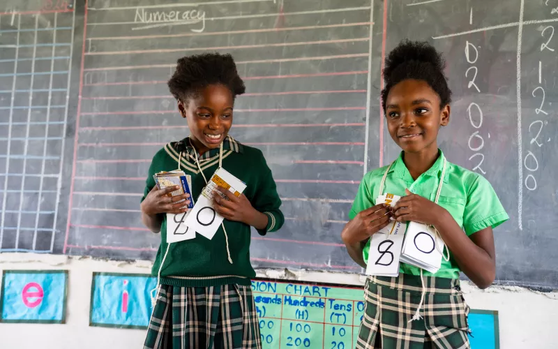 Two learners in front of the classroom during a Catch Up lesson. 