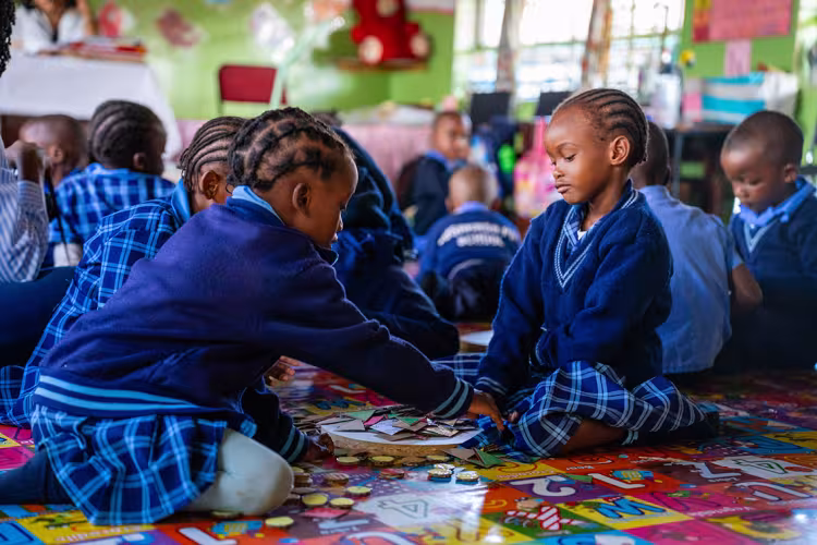 Two preschool children playing in a classroom in Zambia.