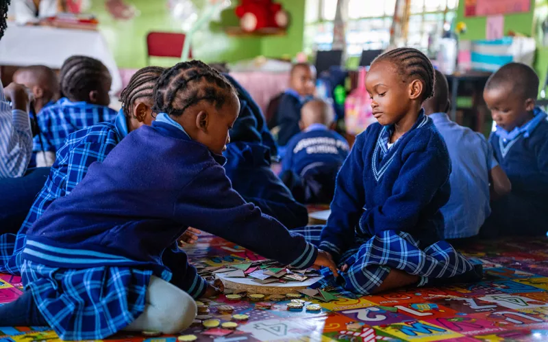 Two preschool children playing in a classroom in Zambia.