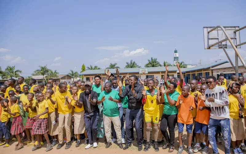 A group of people dancing and clapping their hands. 