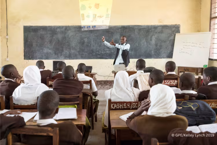 Teacher in Tanzania teaching a class.
