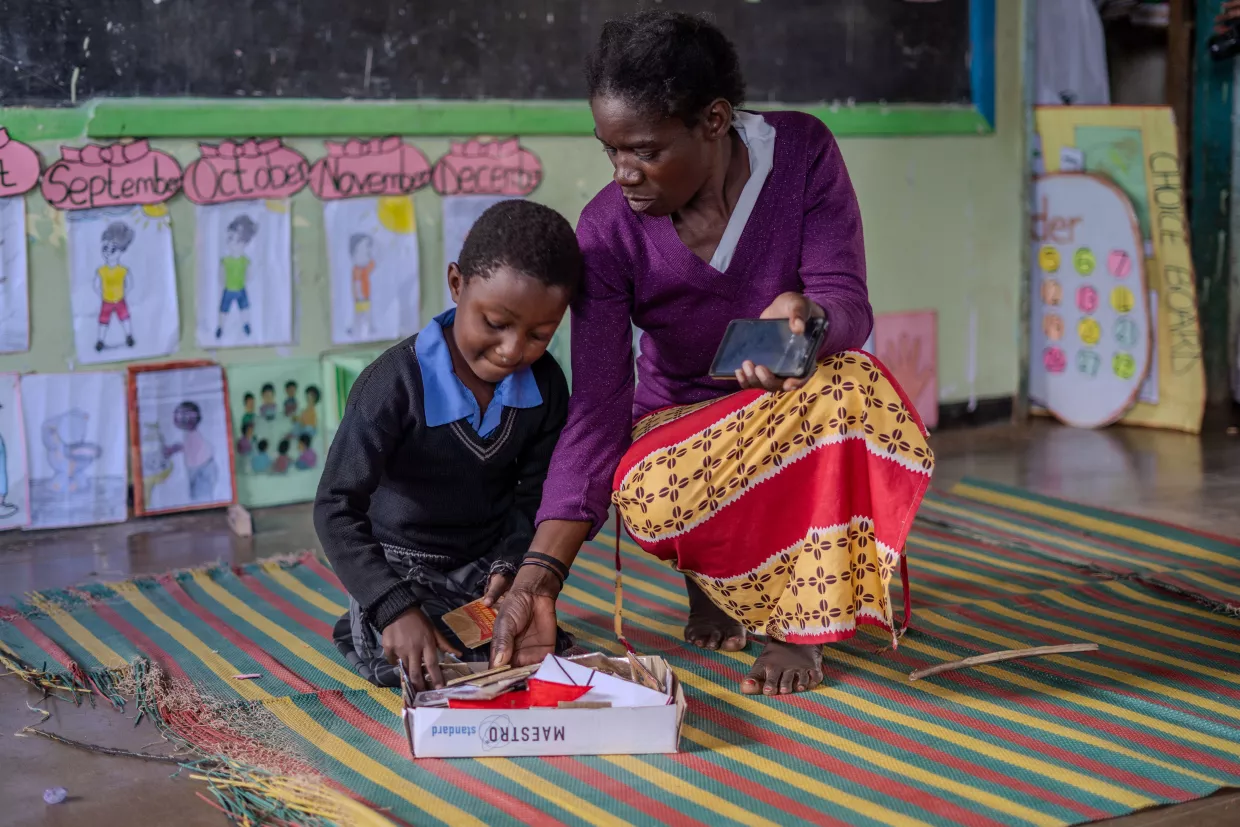 A teacher explaining to a student. 