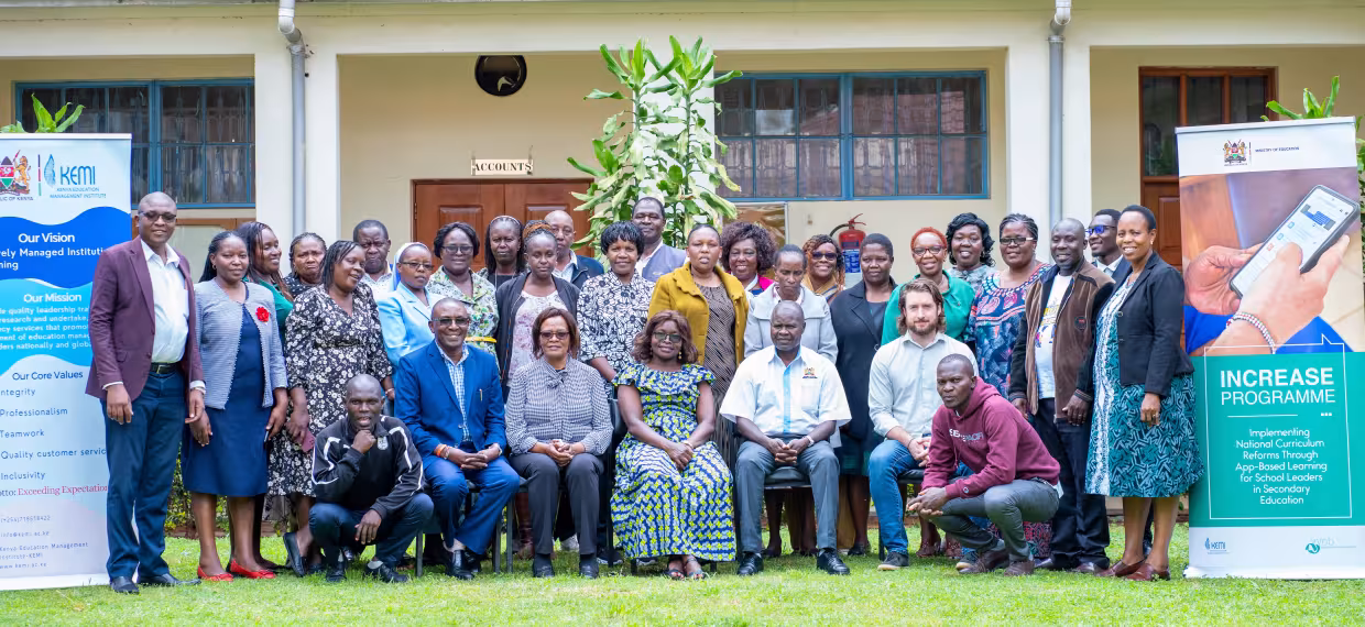 Workshop participants pose together for a group photo outside the training venue.