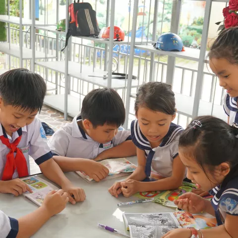 Children play around a table in Vietnam
