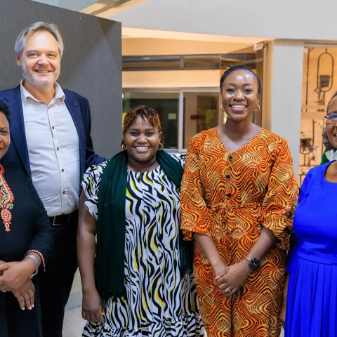 Group photo of five people smiling.