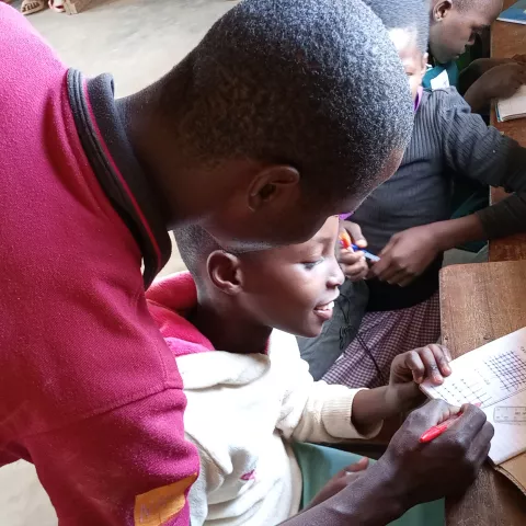 Shem, a Coordinating Centre Tutor is tutoring a young learner.